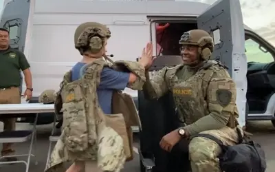 SWAT officer high fiving child