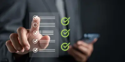 Heads up display floats in air with a list of check marks and lines representing text while a businessman's hand taps on the screen