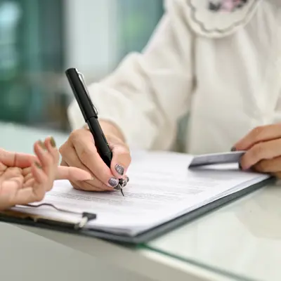 Person helping a person complete a form 