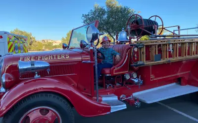 boy sitting in a fire truck
