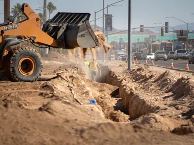 Loader moving dirt for new turn lane