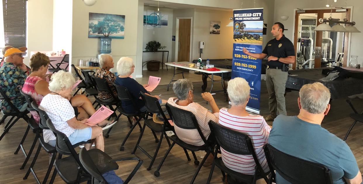 officer speaking at a neighborhood watch meeting