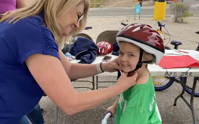 girl getting fitted for a helmet