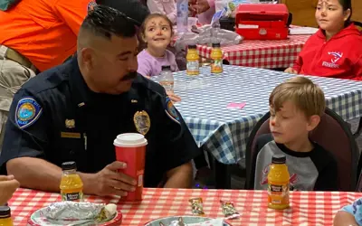officer having breakfast with young boy