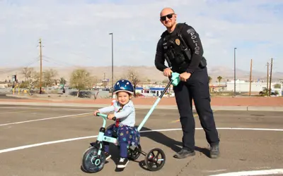 police officer with a child on a bicycle
