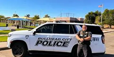 Officer poses in front of police SUV at Ken Fovargue Park
