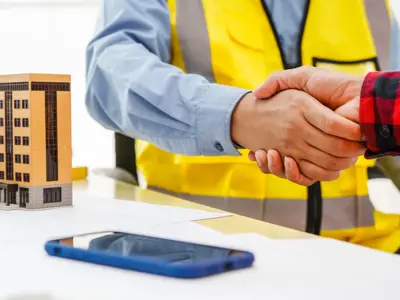 Men in construction vest shacking hands
